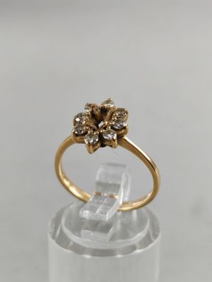 a close up of a gold ring with a flower design on it