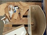 a toilet and a sink sitting on a pallet in a room