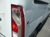 a white van that has been vandalized and is parked in a parking lot