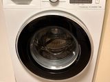 an image of a washing machine in the corner of a room