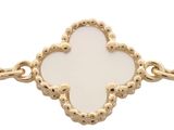 an image of a gold bracelet with a white flower on it