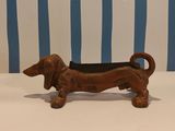 a small wooden dog figurine sitting on a table