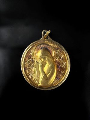 a close up of a gold medal with a woman on it