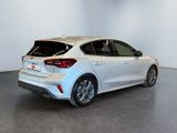 the rear end of a white car in a white room