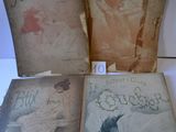 three old books are sitting on a table with a white background