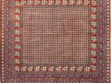 a red and blue rug with a square design on it