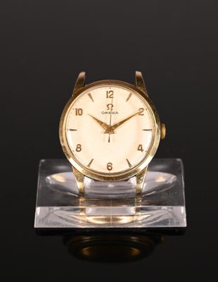 an image of a gold watch sitting on a clear stand