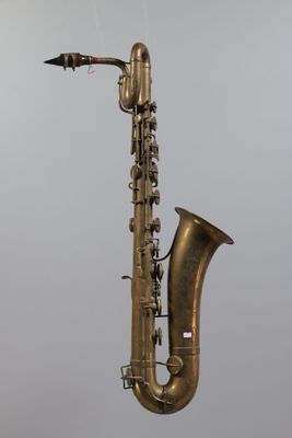 a saxophone hanging from the side of a pole