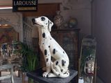 a statue of a dalmatian dog sitting on a table