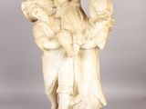 an antique statue of a man carrying a child on his back