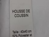 the label on a white shirt reads house de coussin