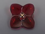 a red glass flower with a gold ring in it