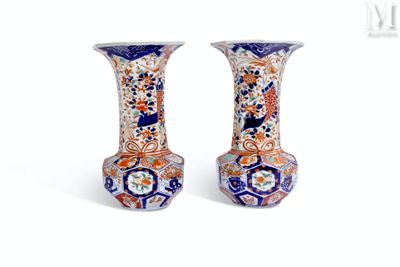 two vases sitting side by side on a white surface