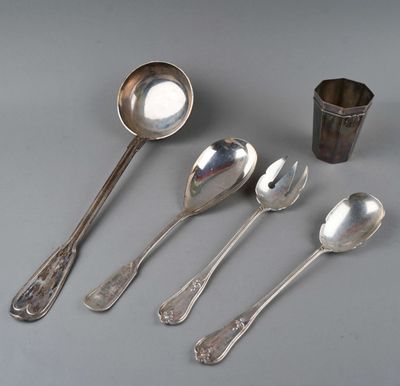 cinq cuillères et une tasse posées sur une table