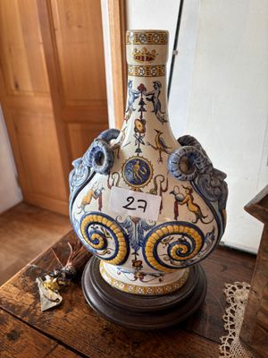 a vase that is sitting on top of a wooden table