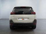 the rear end of a white car in a white room