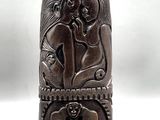 an image of a wooden sculpture of a couple on a bench