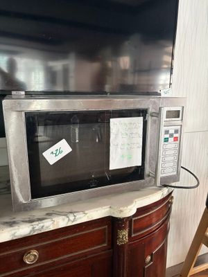 a microwave that is sitting on top of a cabinet