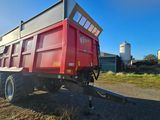 a red dump truck parked on the side of the road