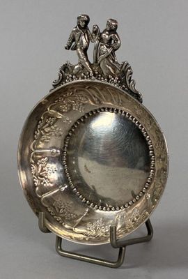 silver plate on stand with angels on top of it