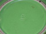 a close up of a green plate on a table