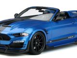 the blue ford mustang convertible is parked on a white surface