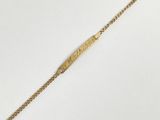 a close up of a gold bracelet on a white surface