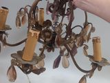 a person that is holding a chandelier in their hand
