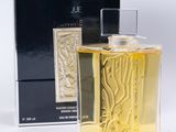 an image of a bottle of perfume sitting next to a box