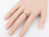 an image of a woman ' s hand with a diamond ring on it