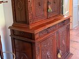a large wooden cabinet in the corner of a room