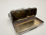 a silver case that is open on a white surface