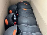 a cardboard box with a bunch of black and orange balls in it