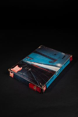 an open book sitting on top of a table on a black surface