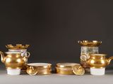 a lot of gold teapots and cups on the table