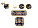 several pieces of blue and gold decorated items including a teapot, tray, and cup