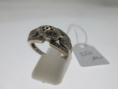 a close up of a ring on a white surface with a price tag