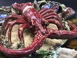 a red lobster on a plate with shells on it
