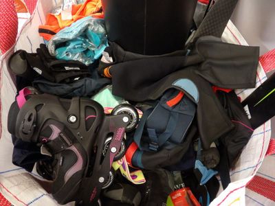 a basket full of luggage that is sitting on the floor