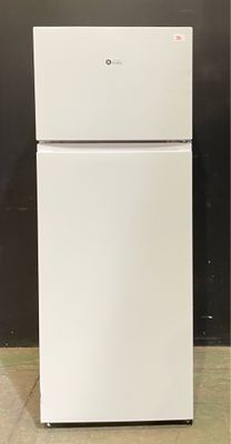 a white refrigerator sitting in a room with a black wall behind it