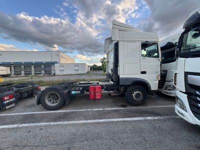 a truck that is parked in a lot with other trucks