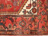an old rug with a red and blue design on a white background