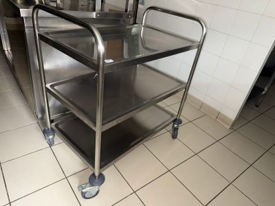a metal cart with three shelves on it in a kitchen
