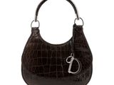the brown purse has a metal handle and a metal handle