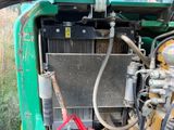 a green truck with a radiator on the back of it