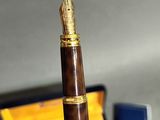 a pen that is sitting on a desk next to a wallet