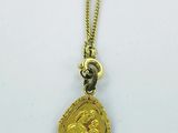 a gold necklace with a gold coin on it