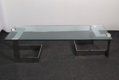 a glass coffee table with metal legs and a glass top