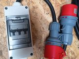 a red and grey electrical outlet and a black and white cord
