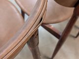 several brown leather chairs are lined up in a row